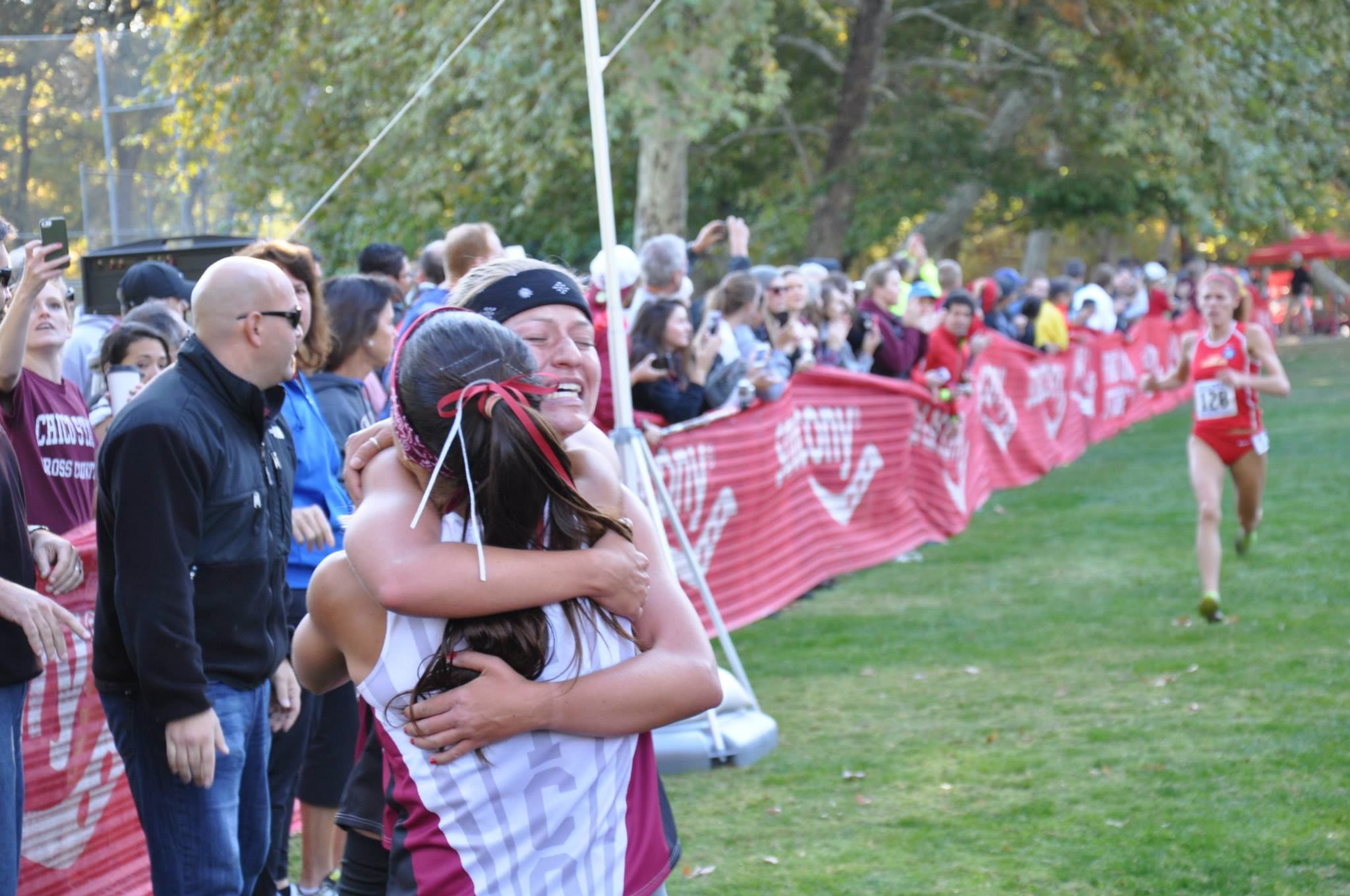 Sara Mikesell overcome with emotion after finishing a strong second, enjoys a post race hug with Ayla at the finish.