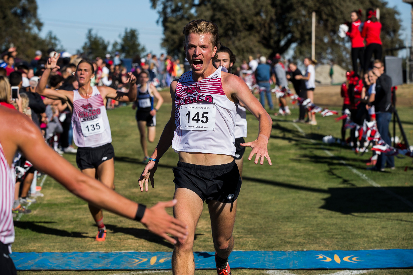 Chico State's Jack Johnson crosses the finish line as teammate Kyle Medina awaits to congratulate him. Contributed Photo by Marty Bicek - Stanislaus State