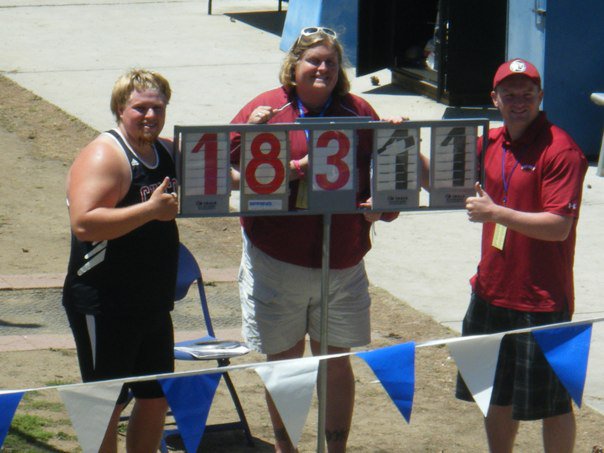Eric Wright with coaches Beth and Matt Jarvis after his big hammer toss