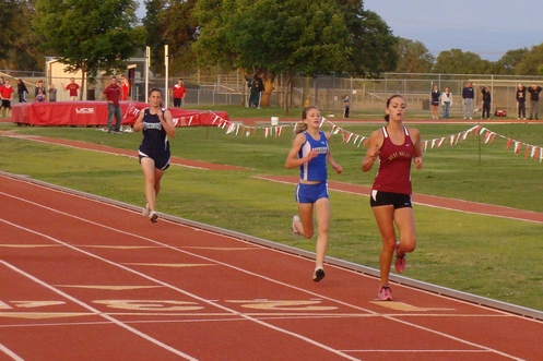 West Valley's Corissa Storms pulls out the win in the girls 3200 despite determined efforts by American Christian's Autumn May and PV's Melanie Hickman. (TC)