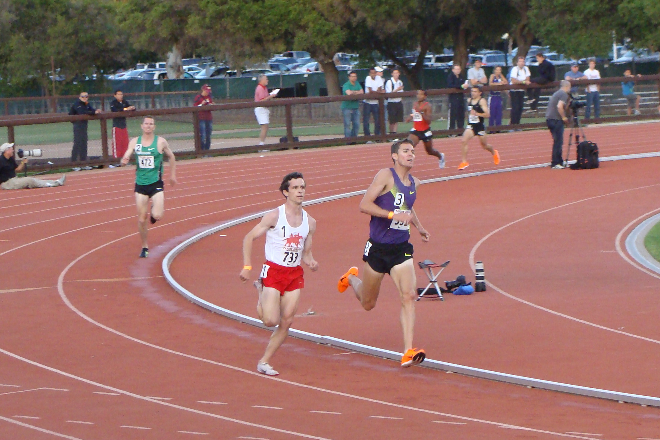 Billy Nelson scoots around Kyle Alcorn to win the fast heat of the men's steeple. Ben Bruce finished third.