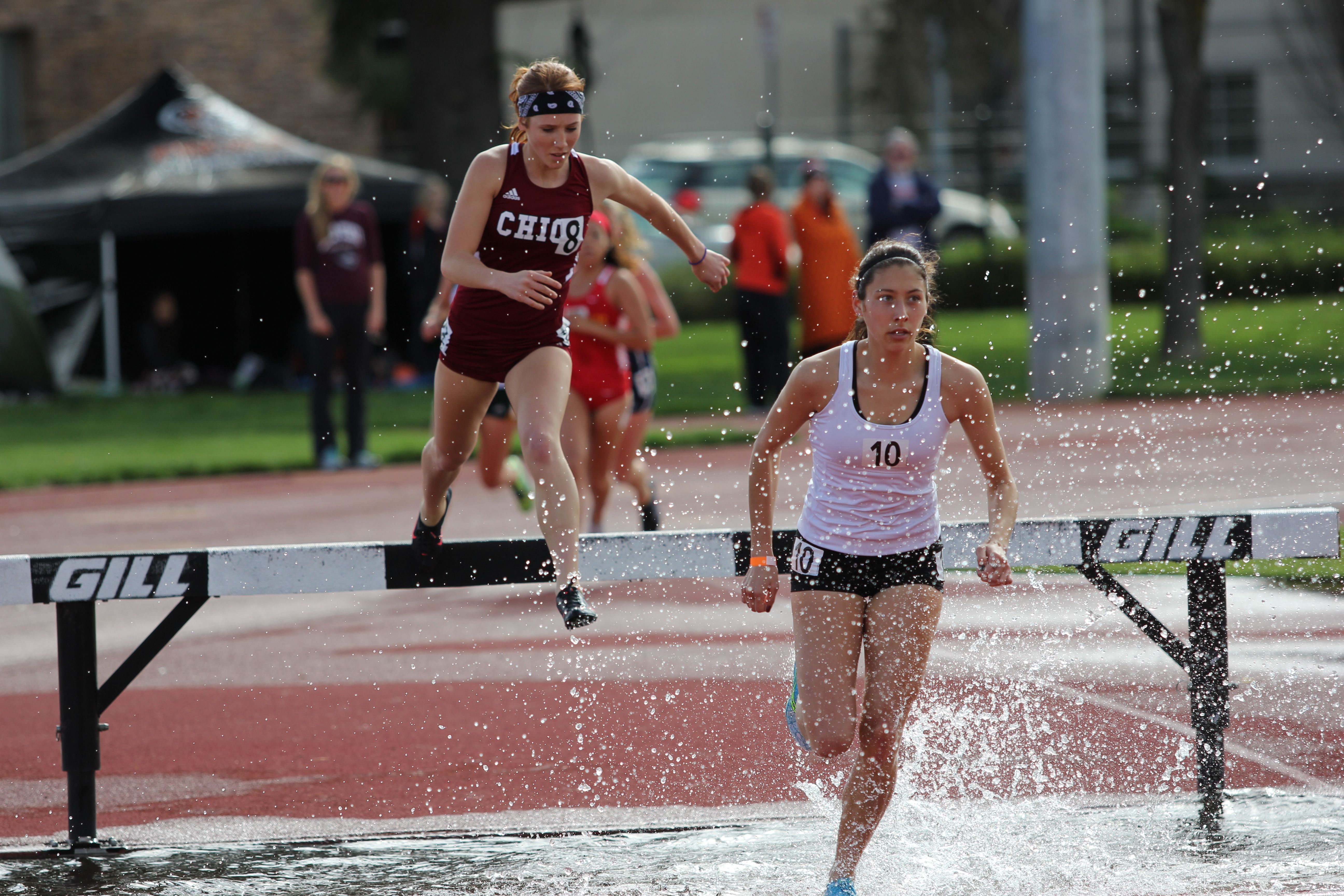 Red Shirting frosh Montana Loveday leads Julie Finn through an early water barrier. Both ran their first steeples ever on Saturday.