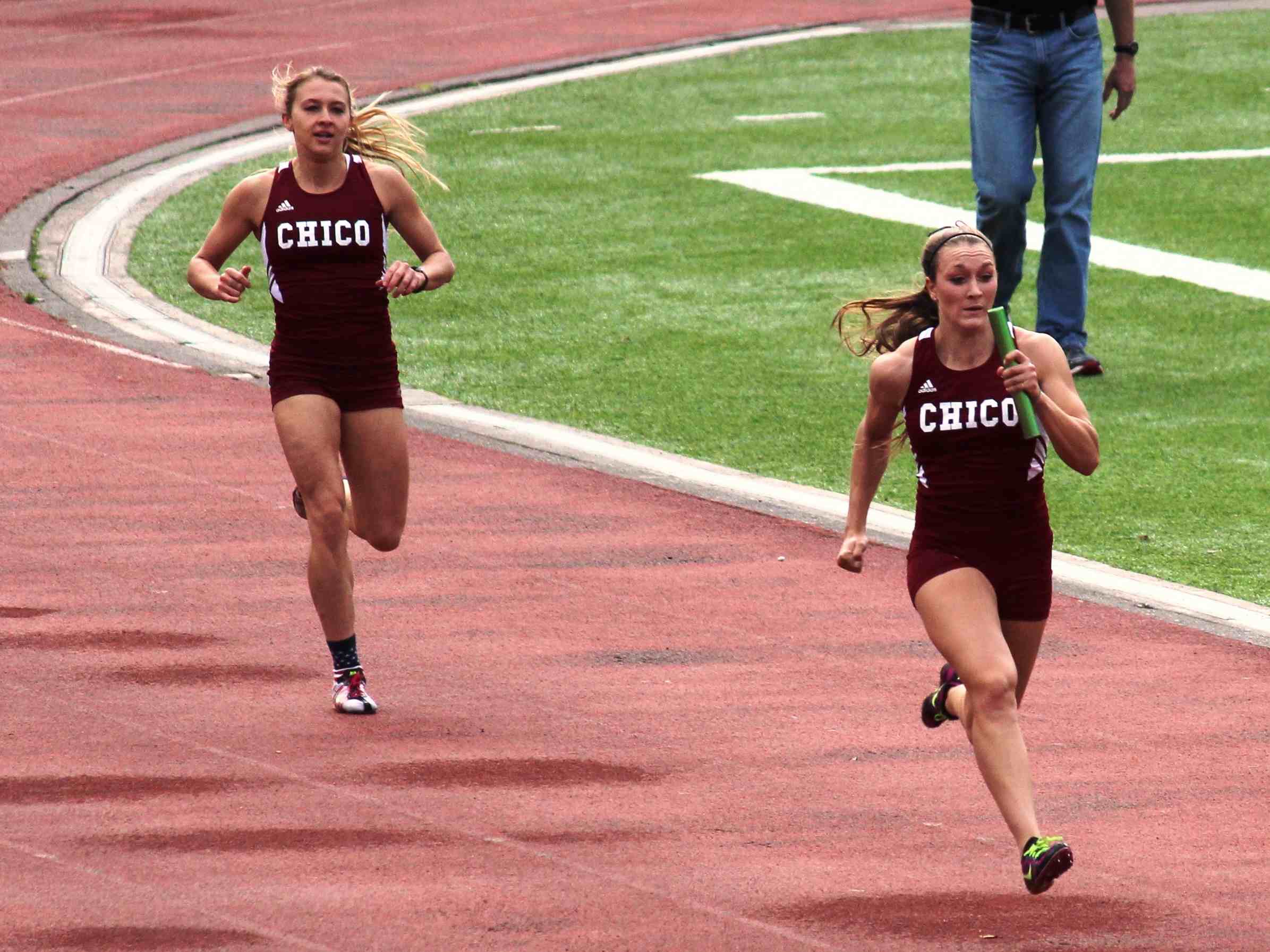 Kasey Barnett taking the baton home from Aja Erksine in the women's 4X100 relay.