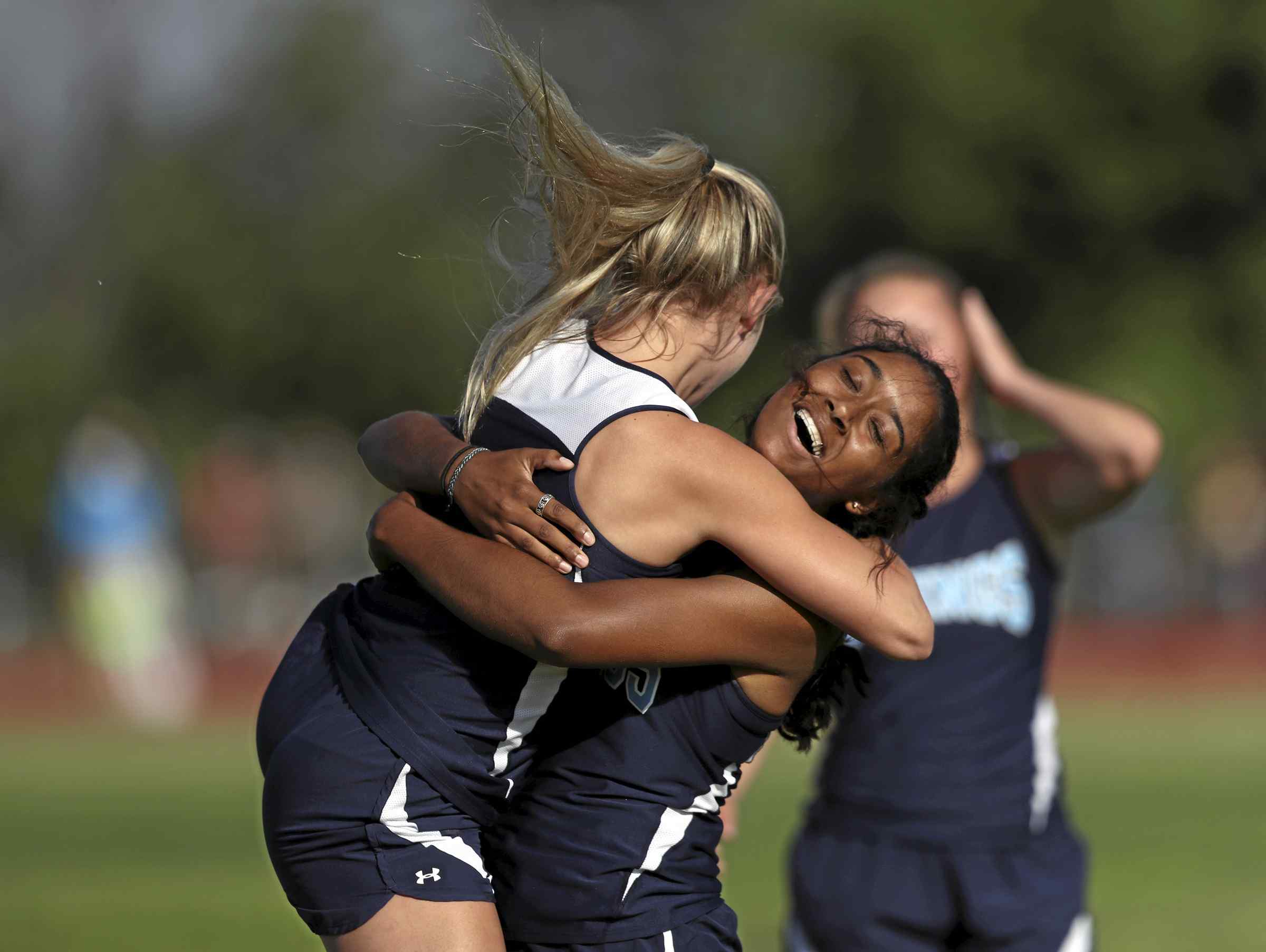 Pleasant Valley High's Jayla Singleton hugs teammate Courtney Kermen after the team's 400-meter relay victory in the Northern Section track and field championships held Friday at West Valley High. (Greg Barnette - RS)