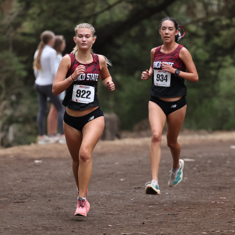 Ava Csutoras running in 3rd overall at the time, leads teammate Isabel Rosales at mid race.