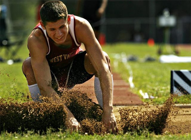 TRUE GRIT: West Valley High School senior Josh McOmber crashes into the pit Friday at the Northern Section Division I finals at Central Valley. McOmber is favored to win the boys Bob Russell Award for athlete of the meet at Friday.