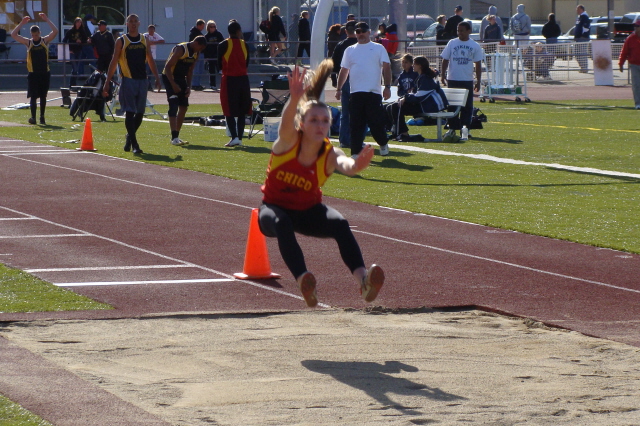 Kasey Barnett sails into pit with the aid of a robust tail wind. After winning the long jump, she and the other competitors wouldn't be so lucky during the triple jump run on the adjoining pit where the runway heads in the opposite direction.