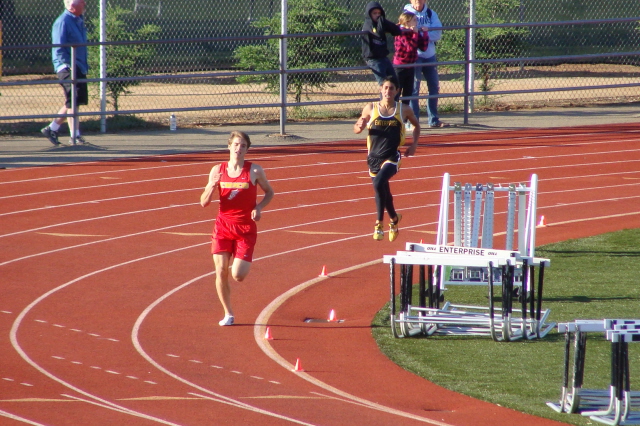 Chico's Dan Parker rounds the final turn in the varsity boys 1600, after surging into the lead early in the backstretch and subsequently opening up a sizeable gap between himself the race's initial pacesetter, Enterprise's Domenic D'Acquisto.