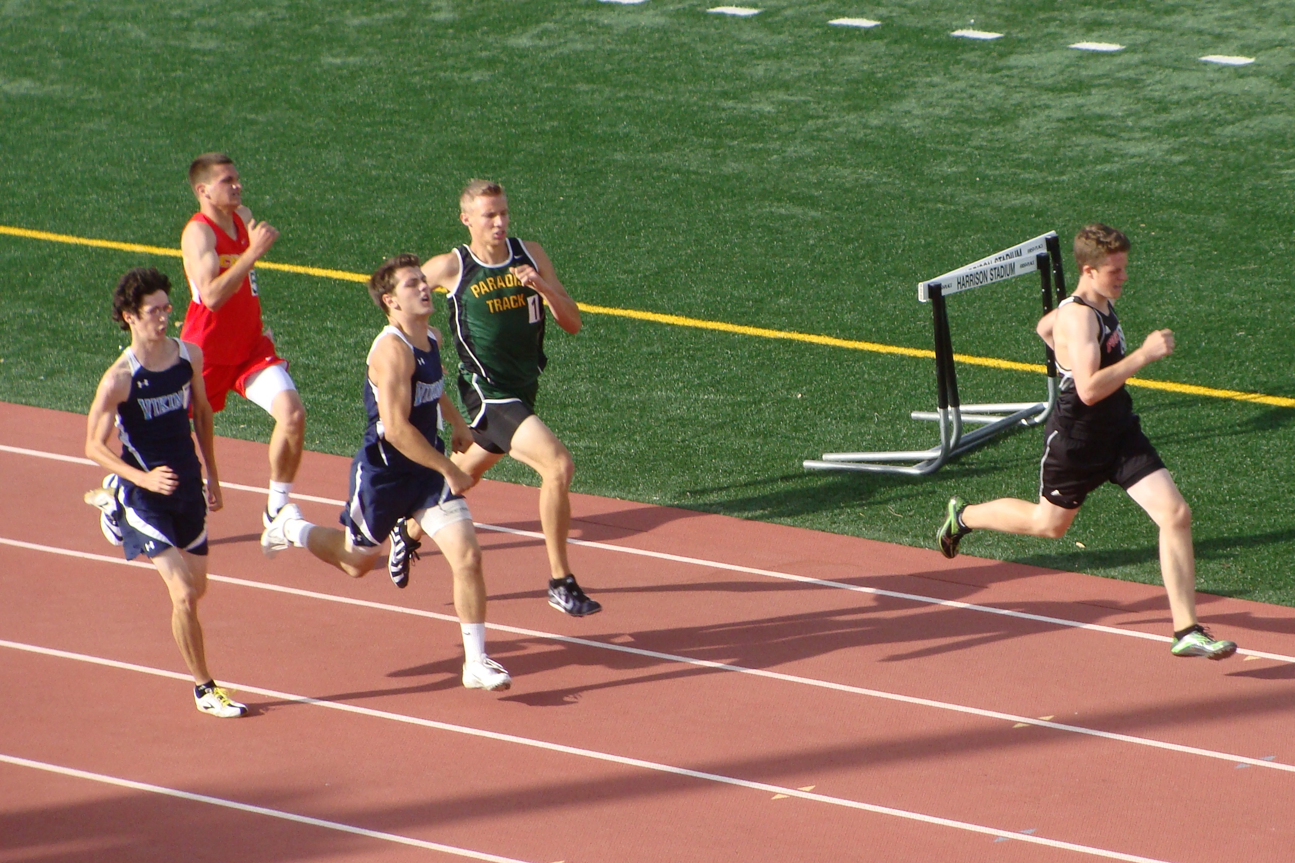 The swoop is on in the JV boys 800. PV's Jason Ellis (far left) would emerge from the crowd to claim the race late as Foothill's Sam Alexander's big first lap lead disappears. (TC)