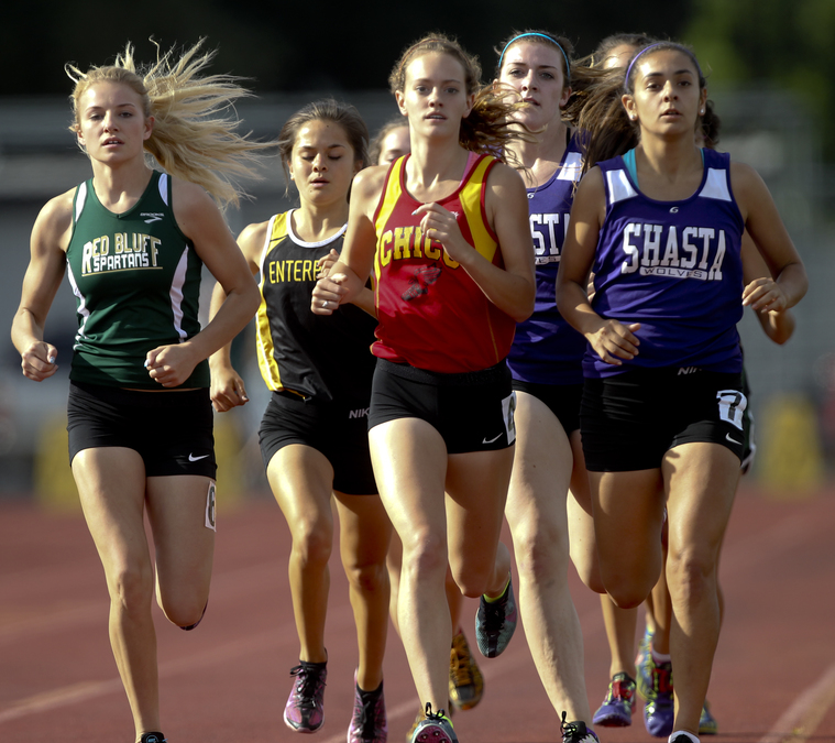 A tight opening lap in the varsity girls 1600. Shasta's Hannah Davis (second from the right) would stretch the race open in lap three and pull away from her closest competitor, Enterprise's Natalie Ulloa (2nd from left) in the final lap to win comfortably. (RS)