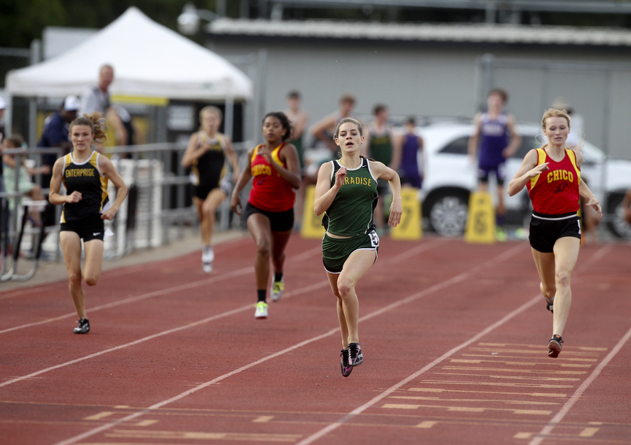 Paradise's Keely Wolfe uses an aggressive start too hold off Chico's Sharlotte Sheffield's patented closing 100, to win the varsity girls 400m. (RS)