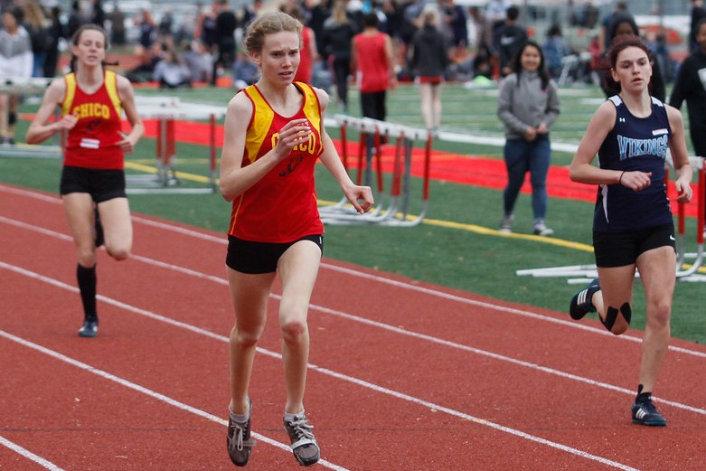 Chico High's Britta Bundy, left, races towards the finish line for a first place win in the 400 meter race and Pleasant Valley's Hailey Askew, right, coming in third as Chico hosts Pleasant Valley in a dual track meet Wednesday April 12, 2017 at Chico High in Chico, California.