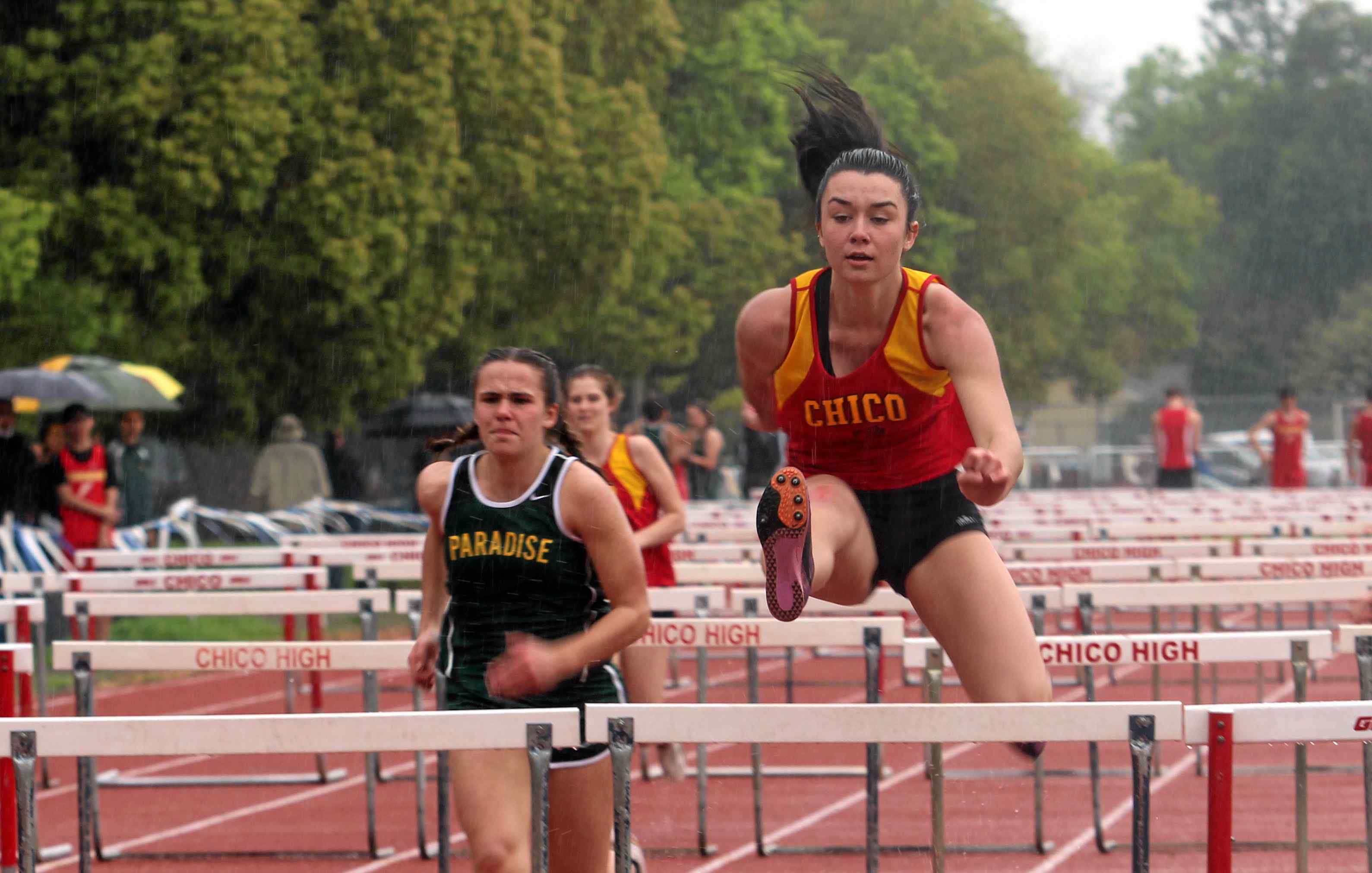 Chico High's Jacey Cornell, right, wins the 100-meter hurdles in a dual meet with Paradise on Monday.